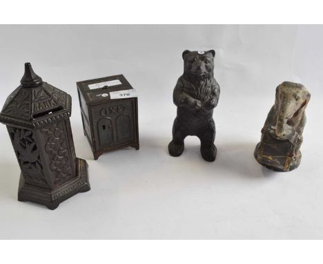 A collection of four late 19th/early 20th Century metal money boxes, some with registered design numbers including one of an 