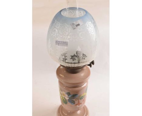 A 19th Century oil lamp, the glass body painted with flowers with glass light blue shade and a burner, 58cm high