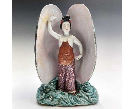 A Chinese porcelain figure within a giant clam, 19th century, four seal marks to underside, height 26cm, width 17cm, depth 13