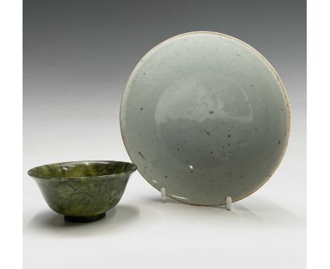 A Chinese celadon bowl, 19th century, square seal mark, diameter 14cm, together with a small jade bowl, diameter 7.5cm (2).