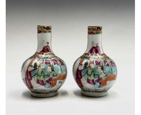 A pair of Chinese Canton porcelain vases, 19th century, of small proportions, with figures in interior setting flanked by bir