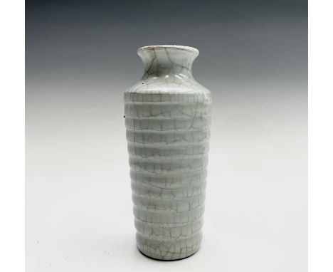 A Chinese Ge type crackle glazed vase, with a ribbed cylindrical tapering body, seal to base, height 20cm, diameter 8cm.Condi