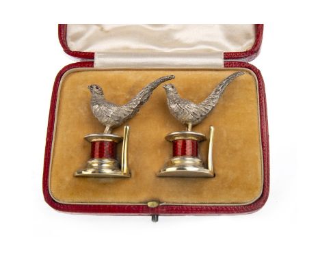 PAIR OF EDWARDIAN SILVER AND ENAMEL MENU HOLDERS, maker WH, London 1908, each modelled in the form of a pheasant on a cylindr