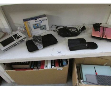A Praktica camera, a Levro II ebook reader, a digital photo frame, radio, binoculars and portable DVD player
