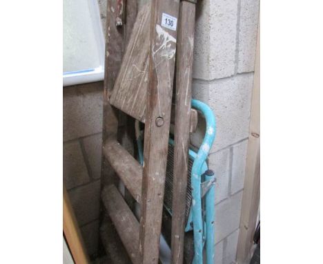 A wooden step ladder and a metal step ladder