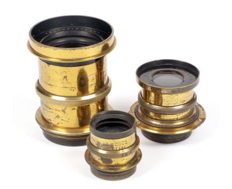 Three Vintage British Brass Camera Lenses. To include large "Sandringham" Rapid Rectilinear model and a Beck Symmetrical, bot