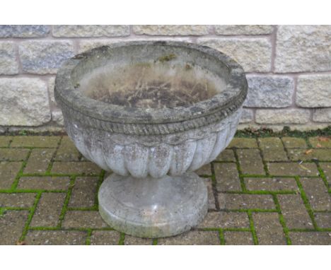 A reconstituted stone planter, circular lobbed body, shaped pedestal. 46cm high x 54cm diameter.