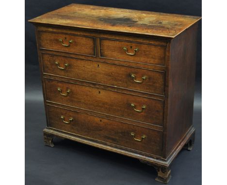 A George III oak chest,  of two short and three long graduated cockbeaded drawers, bracket feet, 89cm high, 92cm wide, c.1800