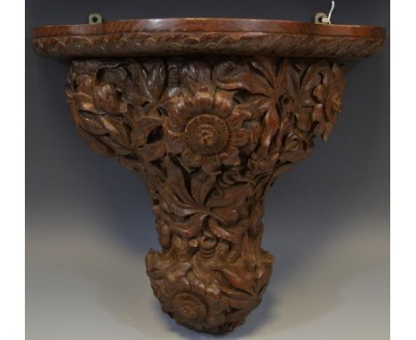 A 19th century Black Forest type wall bracket, carved with wild dog, flowers and foliage, 31cm high, c.1860