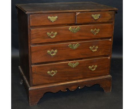 A George III mahogany veneered chest of two short above three long graduating drawers, drop swing handles, batwing escutcheon
