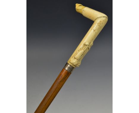 A 19th century walking stick, the the bone handle with whistle and carved with sporting trophies, 92cm long