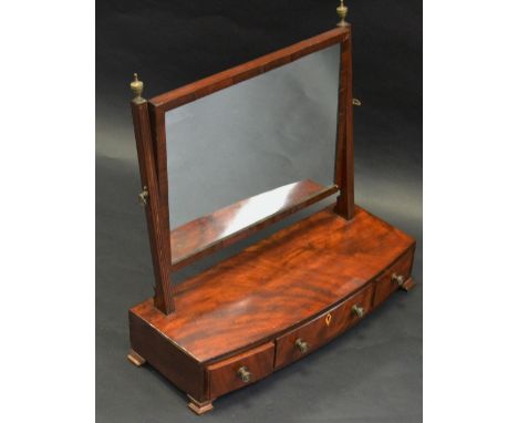 A 19th century mahogany dressing mirror, rectangular plate, brass urn finials, bowed base fitted with three drawers, brass dr