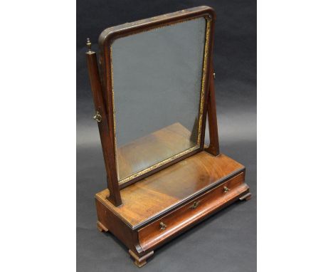 A George II/early George III parcel-gilt mahogany dressing glass, rounded rectangular tilting plate, concave moulded drawer t