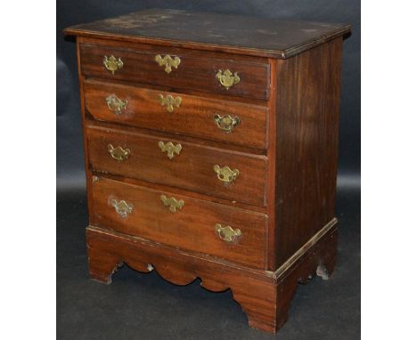 A George III small mahogany veneered chest of four graduating drawers, brass drop swing handles, batwing escutcheon, bracket 