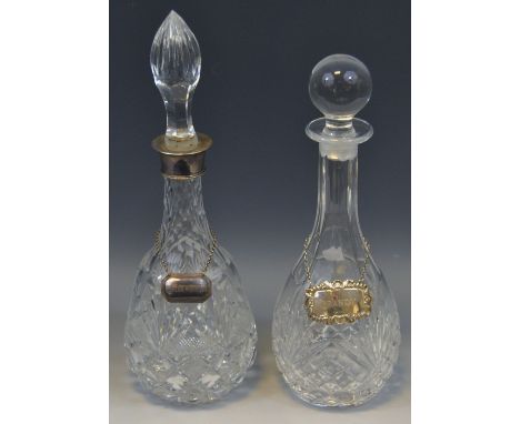 A pair of silver mounted clear glass decanters, hobnail, slice and strawberry cut, lofty slice cut stopper, 31cm high;  anoth