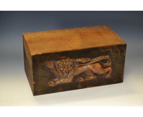 A hardwood corbel or architectural section, carved in relief with a lion passant, 27.5cm wide