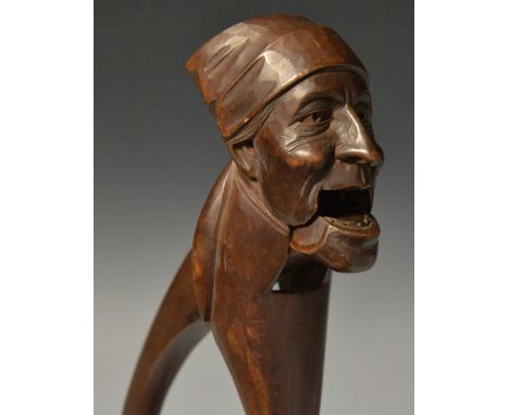 A Black Forest novelty lever action nutcracker, carved as a lady wearing a headscarf, 19.5cm long, c.1900