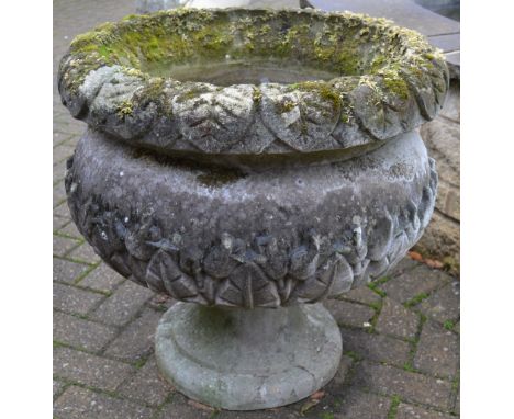A large reconstituted stone planter of globular form, everted rim, leafy carving, slender stem with circular foot. 66cm high 