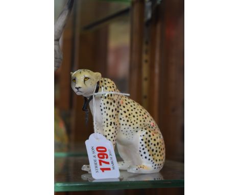 A Royal Worcester figure of a cheetah, No.240, 9.5cm high. 