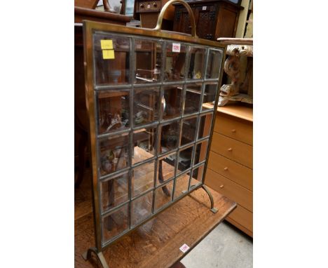 A brass, leaded and bevelled glass firescreen, 52.5cm wide. 