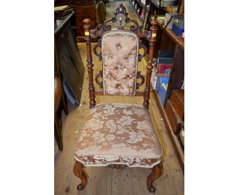 A Victorian carved walnut and button upholstered nursing chair. 