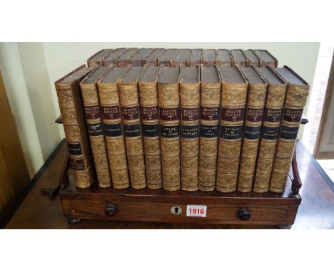 A Victorian rosewood book trough, 38cm wide; together with a set of twenty five volumes of Scott's novels.    