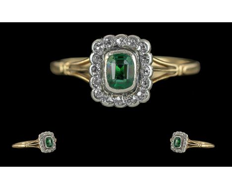 Ladies 18ct Gold Pleasing Diamond and Emerald Set Dress Ring, circa 1920s, marked 18ct to interior of shank, the centre emera