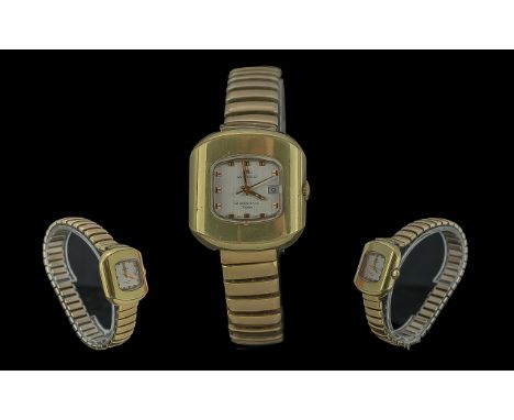 Ladies Movado Queenmatic Video Bracelet Watch, gold tone expanding strap, white face with gold markers and date aperture.  Wo