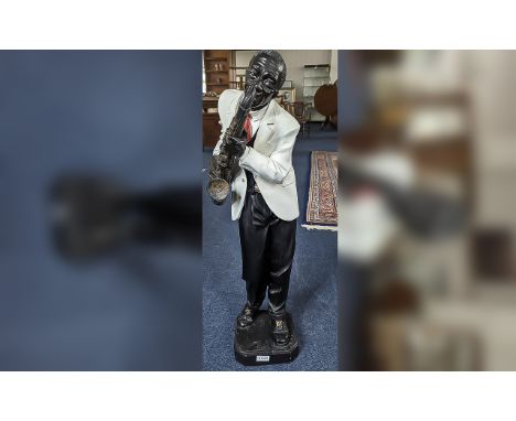 Wooden Saxophone Player Statue, wearing a white dinner jacket and red tie.  Approx. 34'' high.  Great decorative piece for ho