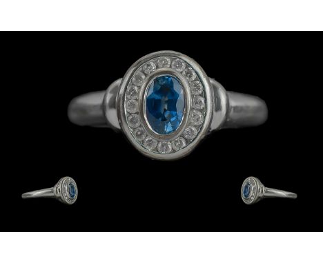 Ladies 9ct White Gold - Pleasing Sapphire and Diamond Set Ring. Full Hallmark to Interior of Shank. The Central Oval Shaped B