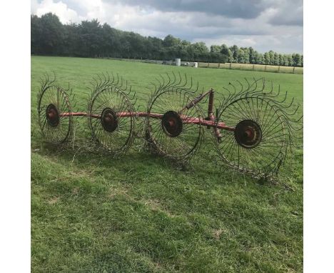 A Vicon tractor mounted hay turner