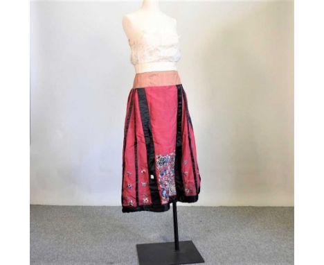 A vintage Chinese red silk dress, richly embroidered with flowers and butterflies, with detailed border and wire strengthened