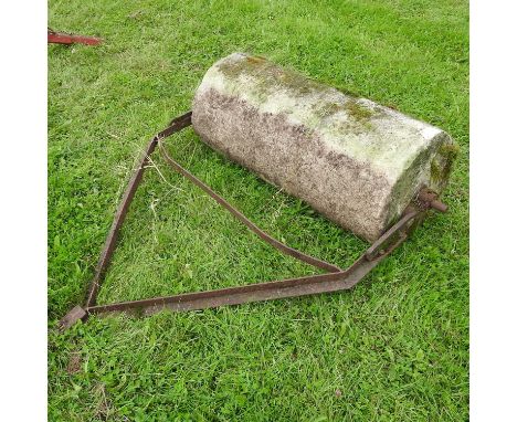 A heavy flat stone roller, with an iron frame