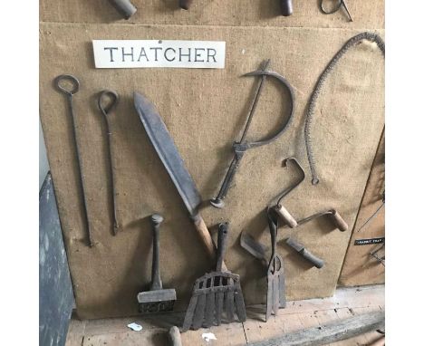 A display board mounted with a set of 19th century thatching tools