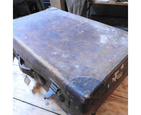 A brown leather suitcase, with initials TFH for 1st Lord Hesketh, containing a collection of vintage shirts and under garment