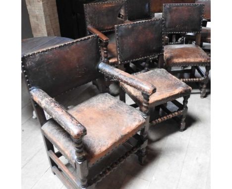 A set of six oak and studded leather dining chairs, early 20th century, on bobbin turned legs