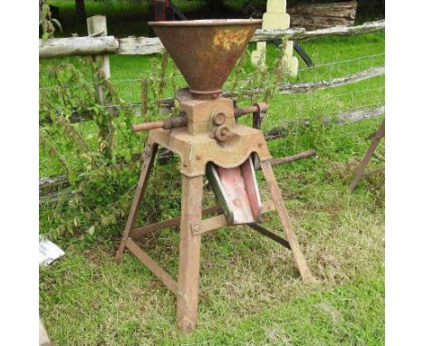An early 20th century Bentall &amp; Co corn grinder, on a splayed stand122cm high