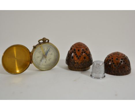A group of modern design items comprising a pair of green and gold metal candlesticks with raised circular bases with spindle