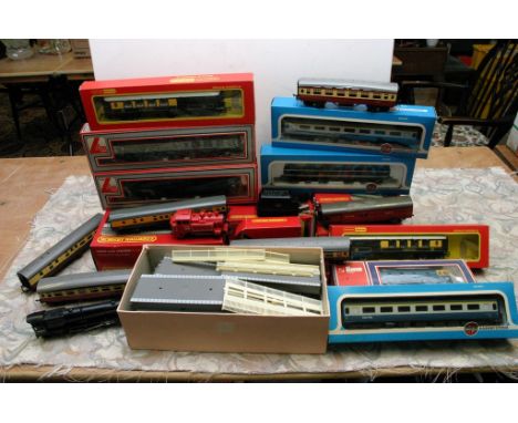 A box containing a collection of boxed and unboxed "OO" gauge model railway locomotives and carriages including Hornby, Lima,