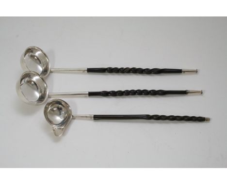 A silver toddy ladle plus two others.
