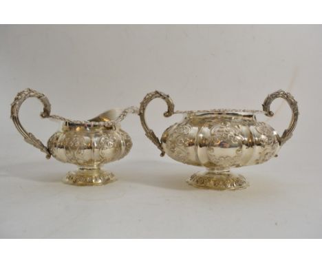 A fine quality Georgian  silver teapot and sucrier  with repousse  scrolled decoration and  blank cartouches, hallmarks for L