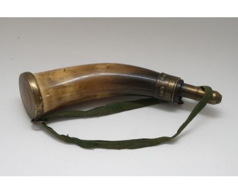 A horn powder flask with brass mounts.