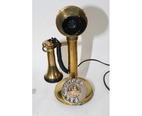 A brass candlestick telephone.