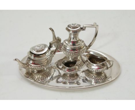 A miniature silver tea and coffee service having half gadrooned decoration.
