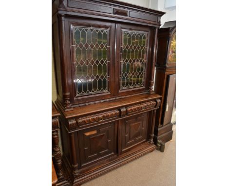 A large 19th century oak cabinet having a pair of lead light doors and under cupboard