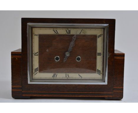 An Art-Deco, oak and chrome mantle clock of stylish design with inlaid banded decoration, the dial with chrome hands and deta