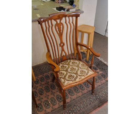 A Victorian beech stick back chair with open arms and upholstered seat on turned legs