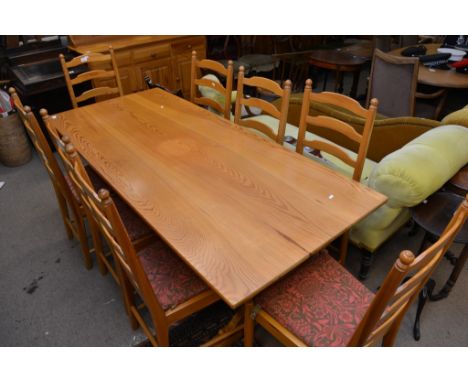 A pine dining room suite comprising a refectory type table a dresser with a raised back and a set of eight ladder back dining