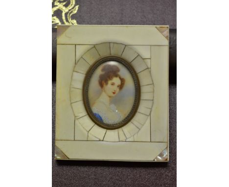 An ivory and mother of pearl framed miniature portrait of a late 18th / early 19th century lady.