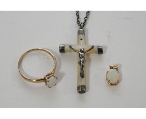 A 9ct gold ring set with an Opal together with a matching pendant and a mother of pearl crucifix on a chain with white metal 